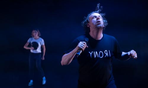 scene image of Oh Man! … 2 actors in a dark room